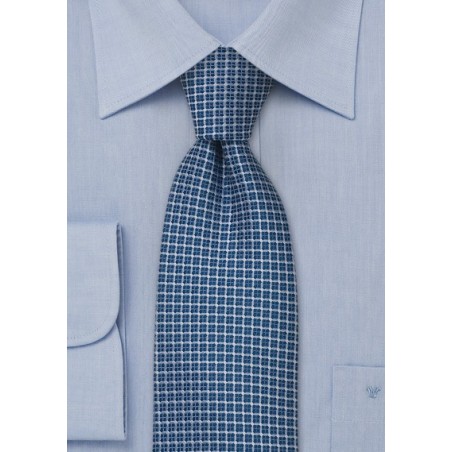 Blue silk tie with checkered pattern