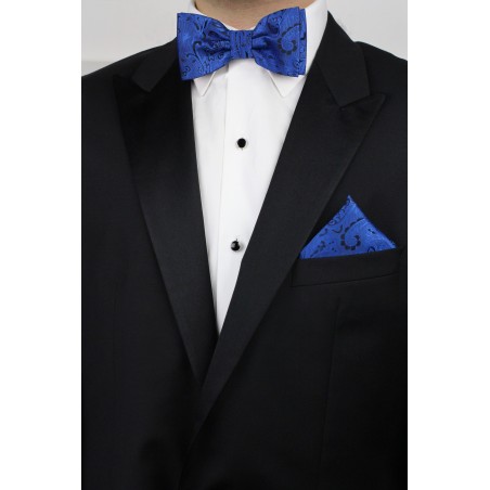 Pre-Tied Paisley Bow Tie in Royal Blue with matching pocket square styled with tux Jacket